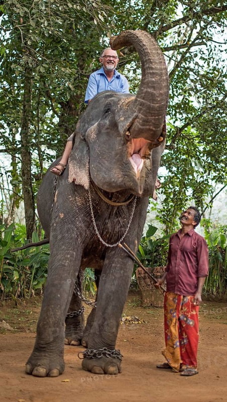 Tourist riding an elephant and mahout or elephant guide