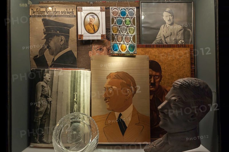 Showcase with Hitler portraits and bust