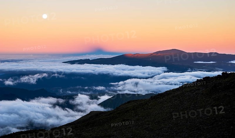 Moonrise and sunset over the Piton de la Fournaise volcano