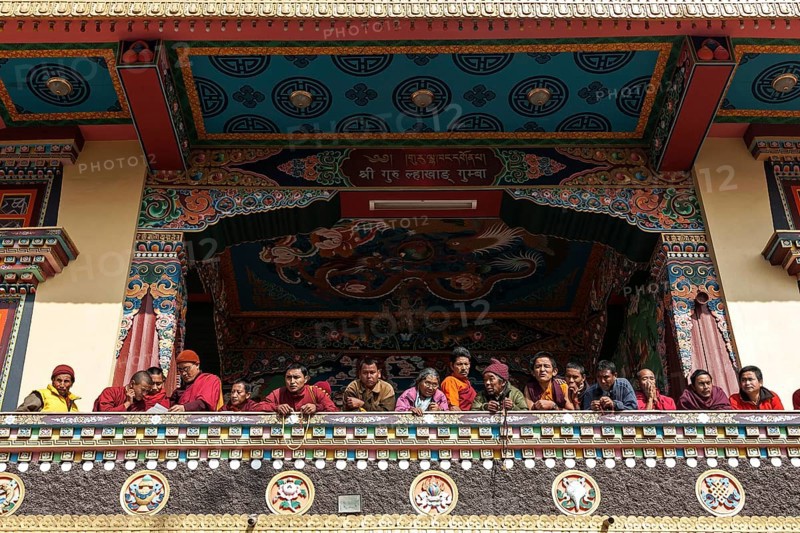 Native people on the balcony of the Cinya Llama Gompa