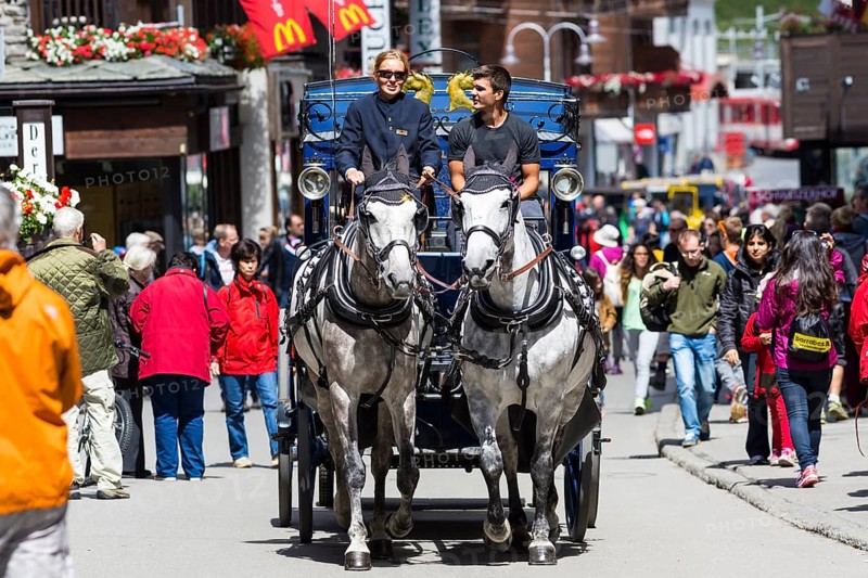 Horse-drawn carriage in Zermatter Bahnhofstrasse street
