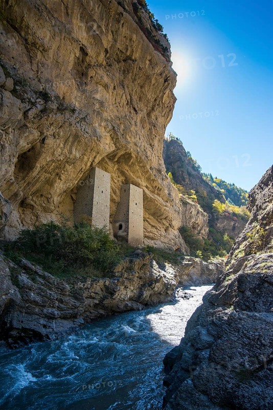 Chechen watchtowers under overhanging cliff on the Argun river