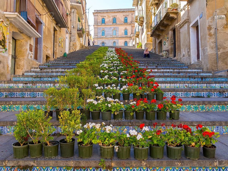 The Santa Maria del Monte staircase with ceramic tiles and potted plants