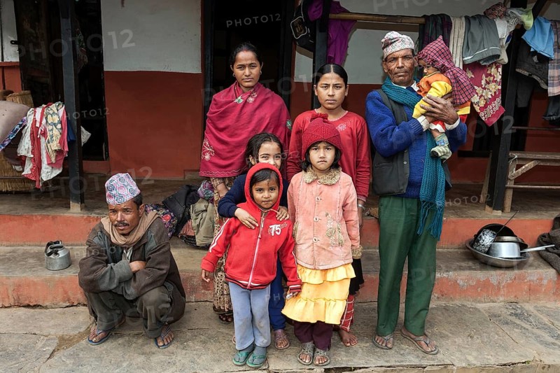Nepalese family in front of their house
