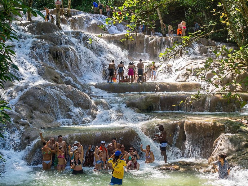 Tourists bathing and climbing the Dunn's River Falls