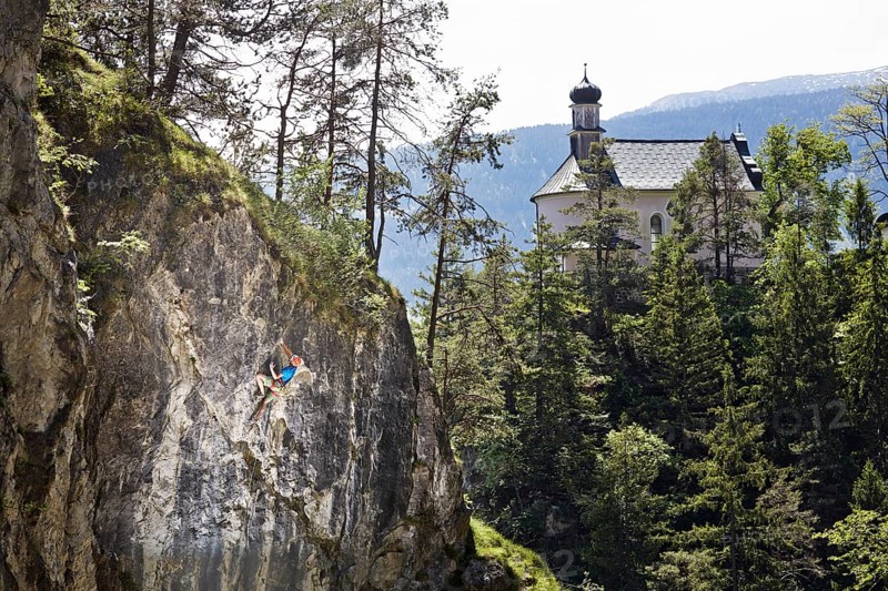 Sport climber climbing a rock face