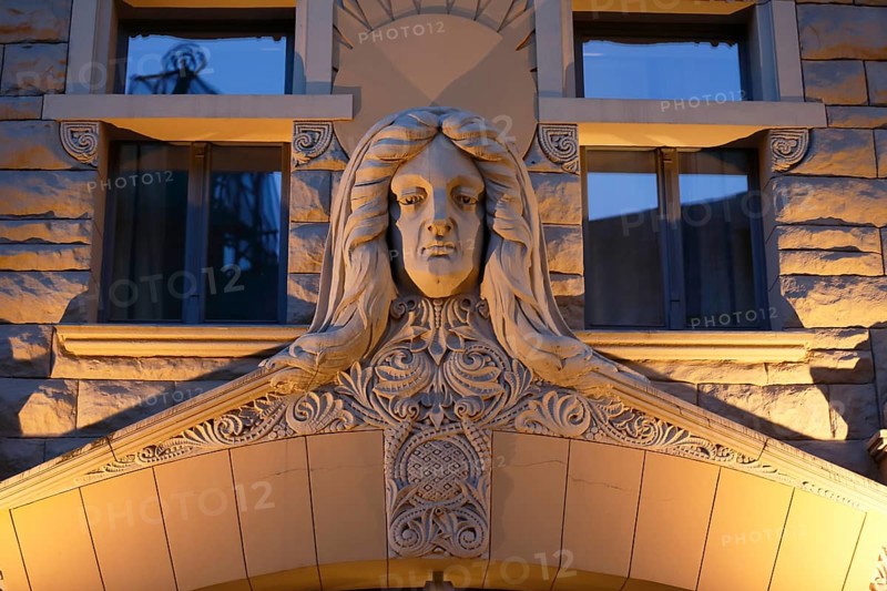 Sculpture of a woman's head over the Art Nouveau entrance of the Neiburgs Hotel