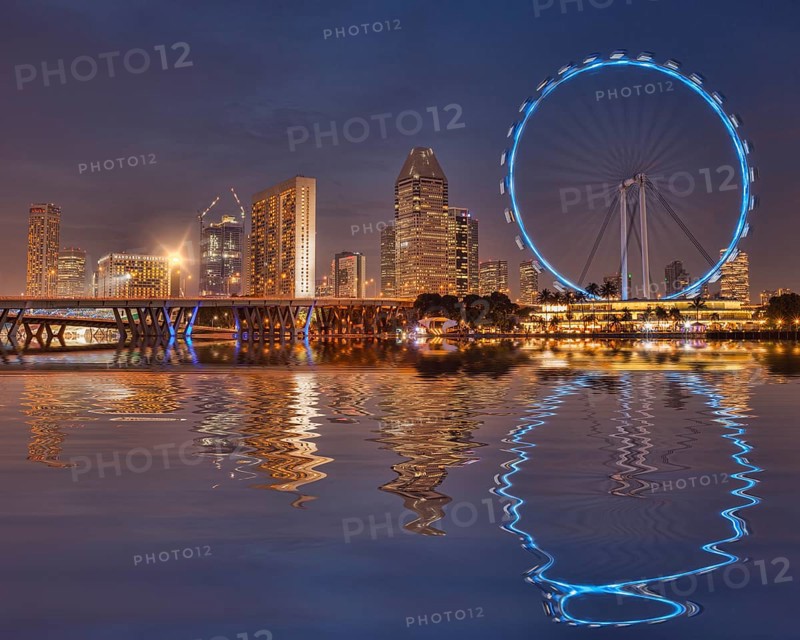 Singapore Flyer and Skyline reflected in the waters of Marina Bay