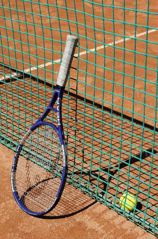 Tennis racket next to net