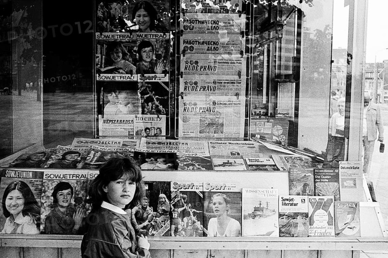 Girl in front of a kiosk of the Post-Zeitung Vertriebes PZV of the GDR in Dunkerstrasse