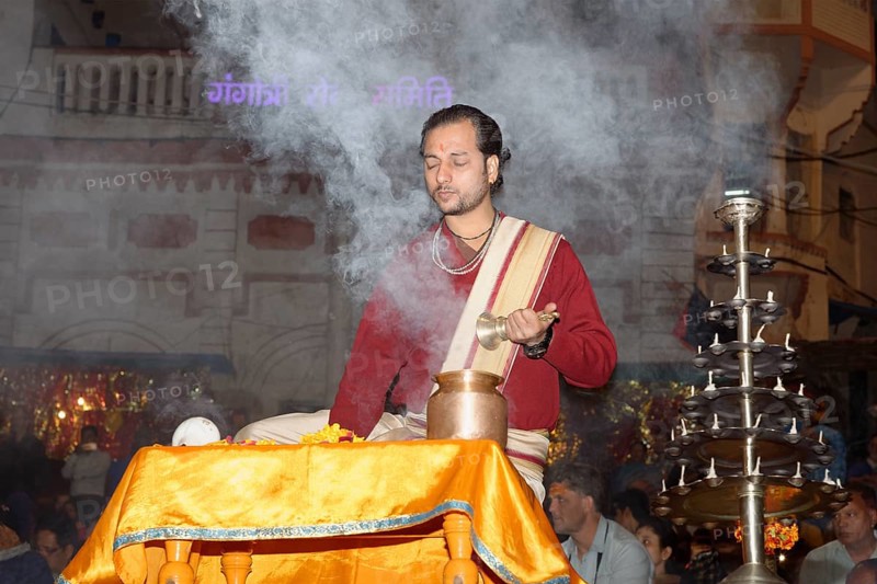 Priest celebrating the Aarti by offering incense