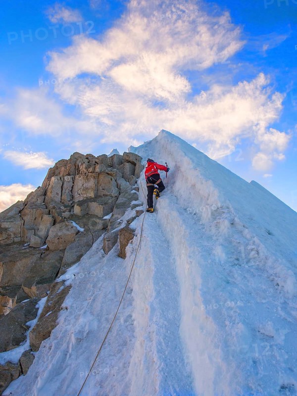 Roped alpinist climbing
