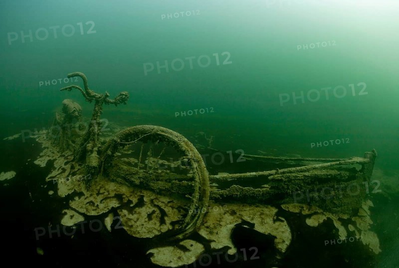 Rowing boat wreck with sunken bike