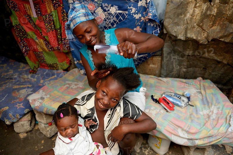 Mother braiding in her daughter's hair
