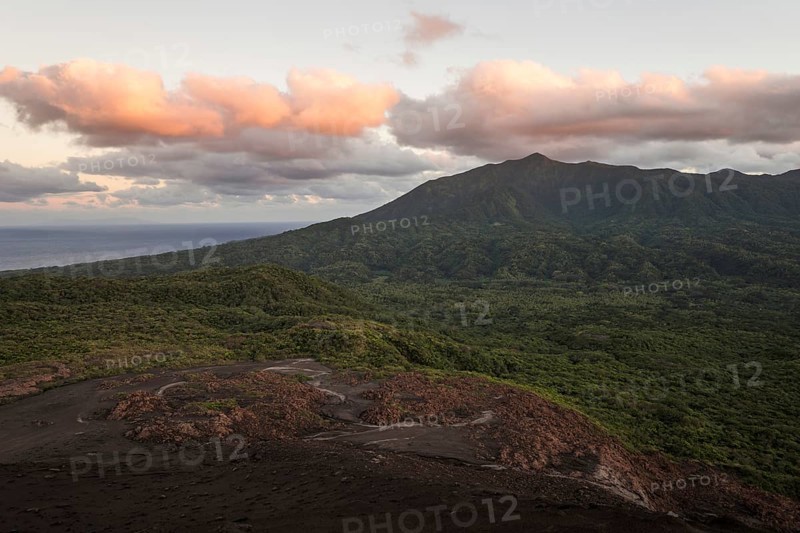 View from the crater of Mount Yasur volcano onto the sea in the morning light