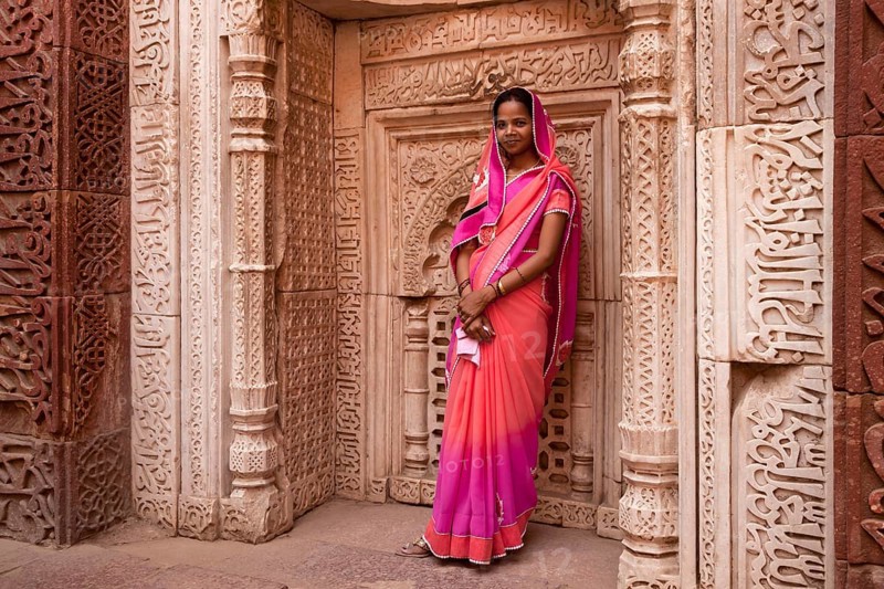 Young Indian woman posing in the Qutub Minar Complex or Qutb Complex