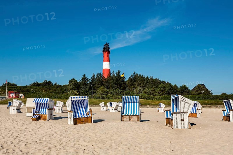 Beach chairs on the beach in front of the lighthouse