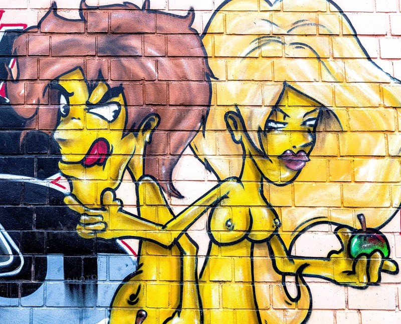 Adam and Eve graffiti on a wall