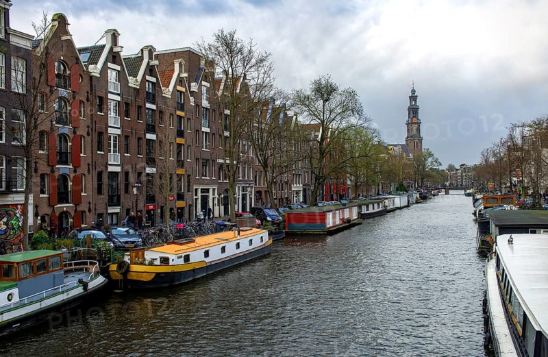 Houseboats on Prinsengracht with Westerkerk tower