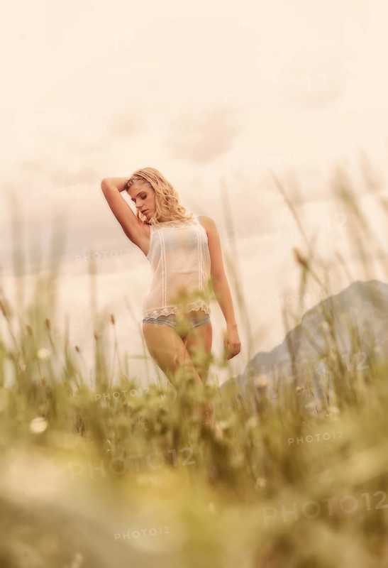 Young woman in lingerie posing outdoors