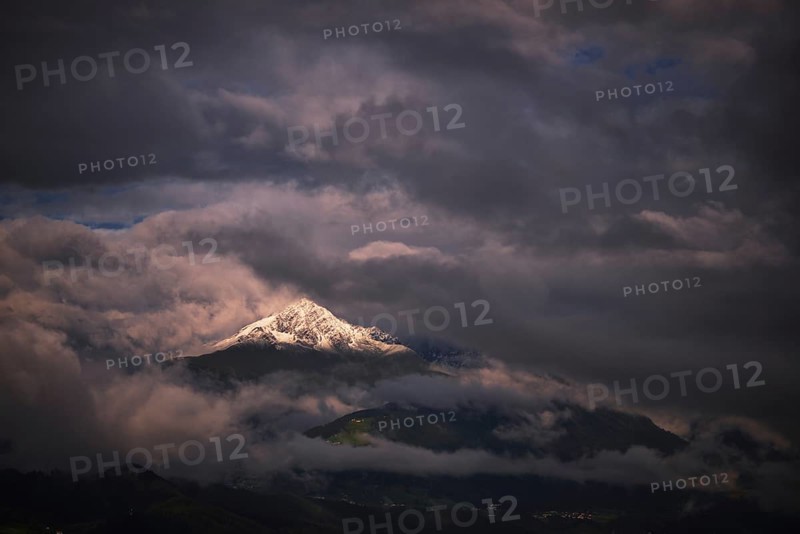 Snow-capped Mt Rosskogel with looming clouds