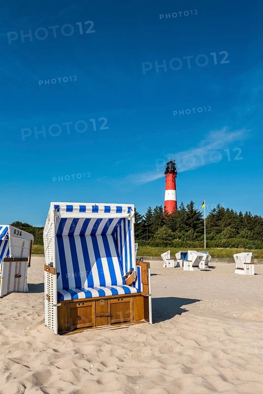 Beach chair on the beach in front of the lighthouse