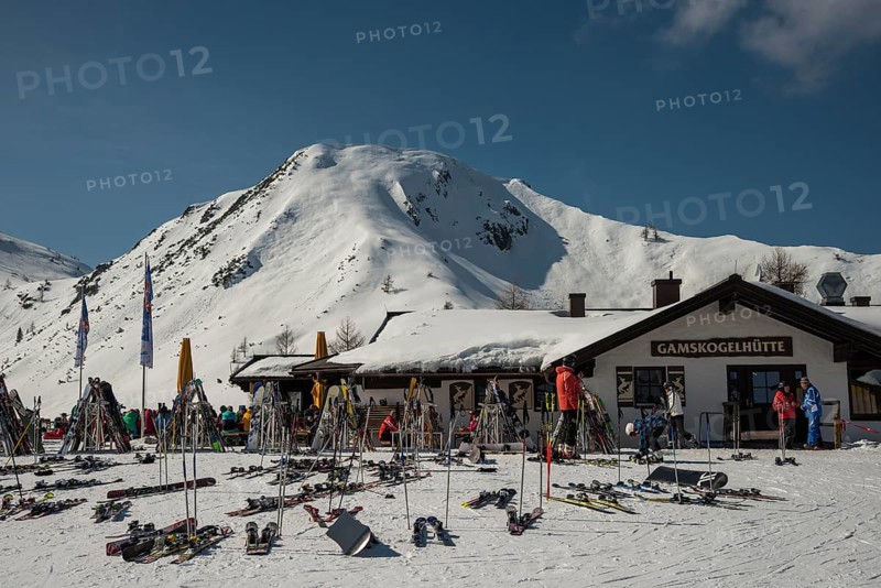 Ski slope with signposts and a few skiers on Gamskogel