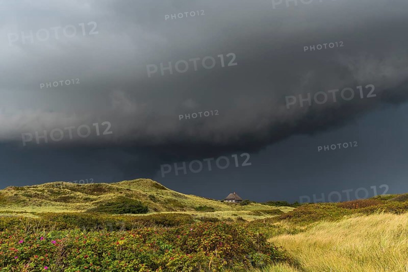 Dramatic storm clouds over dunes