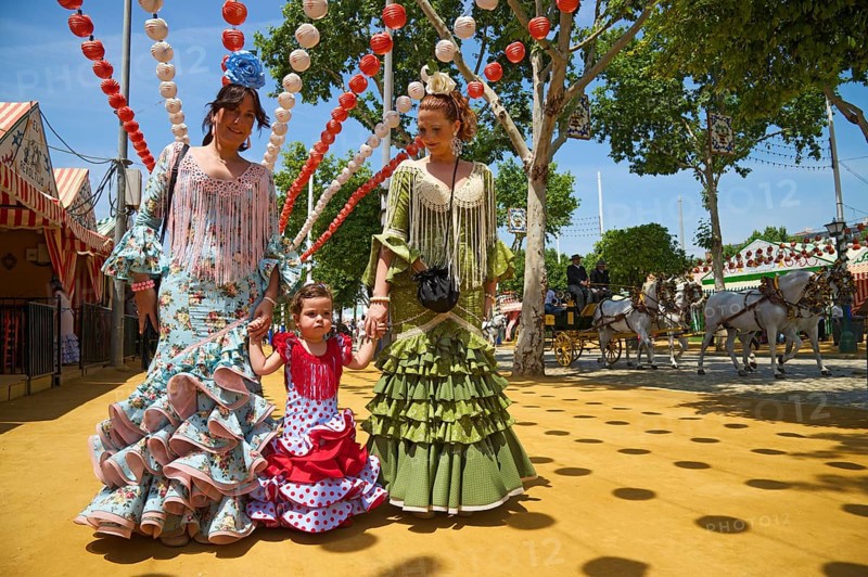 Flamenco dancers and little girl at the Feria de Abril