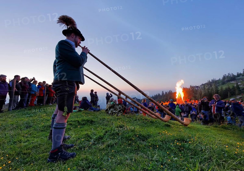 Alphorn players and bonfires