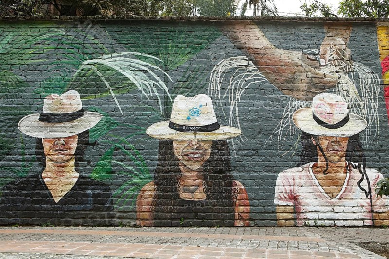Painting of two men and a woman wearing Panama hats