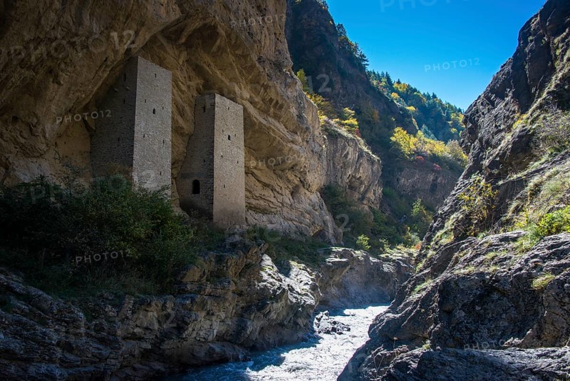 Chechen watchtowers under overhanging cliff on the Argun river