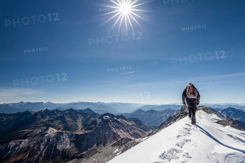 Mountaineer descending via the summit ridge from Mt Hoher Weisszint