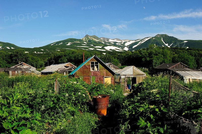 Small settlement with greenhouses heated by thermal springs near Kurile Lake