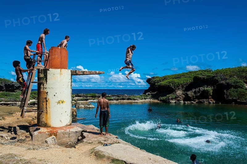 Local boys jumping and swimming in the Salugula Pool