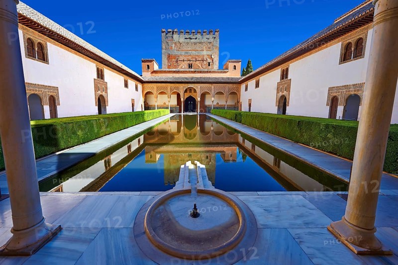 Arabesque Moorish architecture and pond of the Court of the Myrtles of the Palacios Nazaries