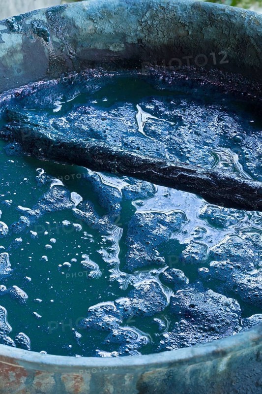 Silk dye container with blue pigment at a silk making factory