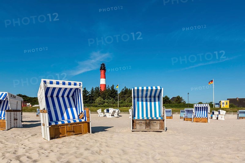 Beach chairs on the beach in front of the lighthouse