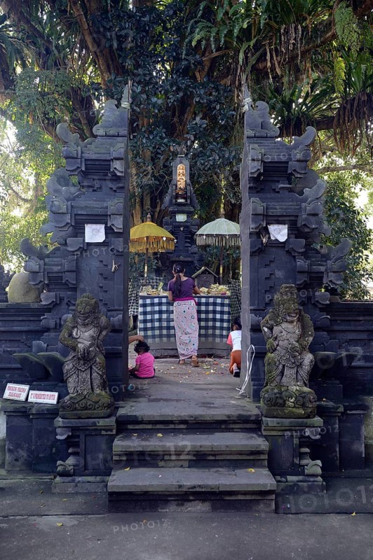 Believers making offerings in a small side temple