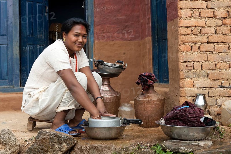 Nepalese woman doing the dishes