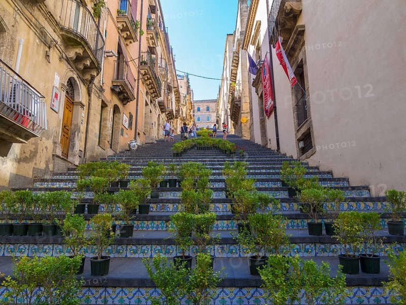 The Santa Maria del Monte staircase with ceramic tiles and potted plants