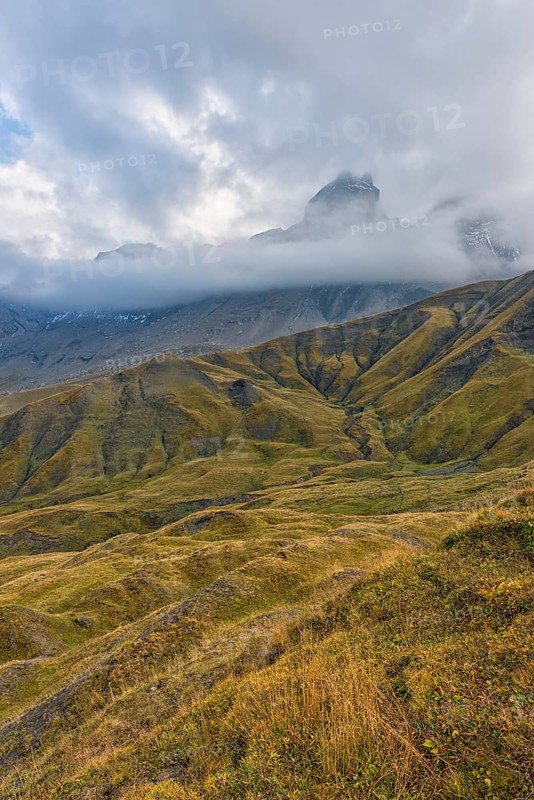 Pelvoux landscape with the Les Aiguilles d'Arves mountain between fog and clouds