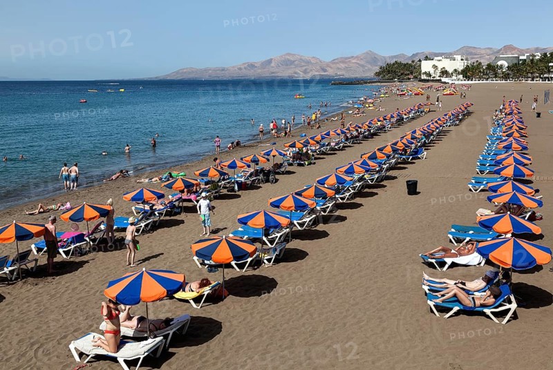 Playa Blanca beach with parasols and sun loungers