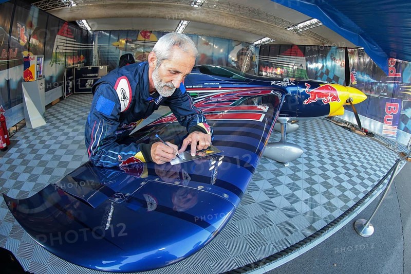 Peter Besenyei posing with his plane before the Red Bull Air Race