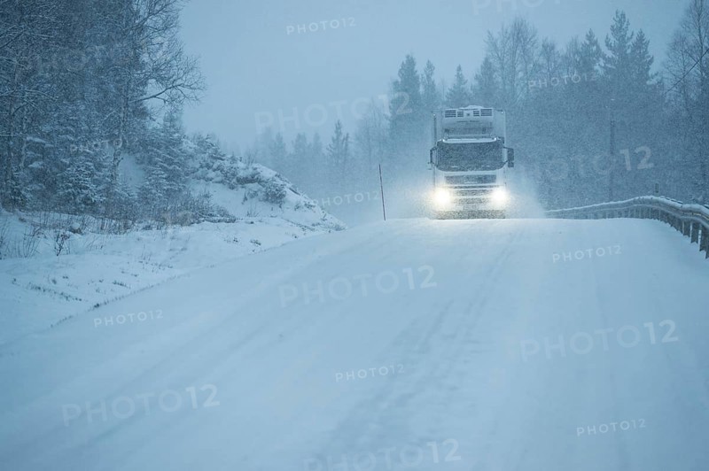 Truck driving on snowy road