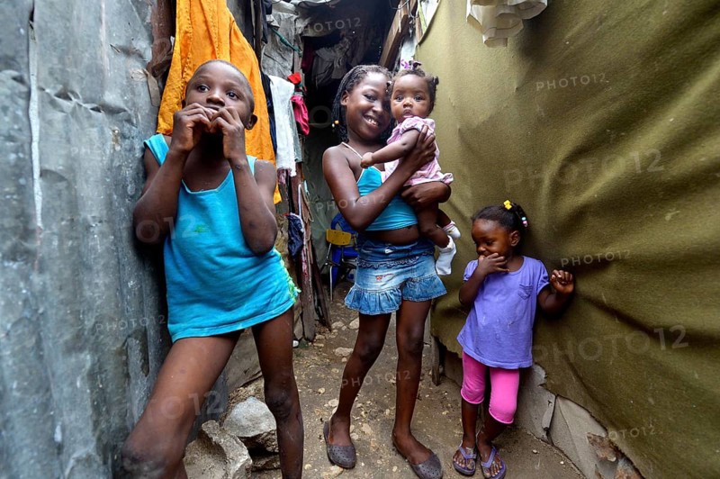 Four children in the entrance of a shack