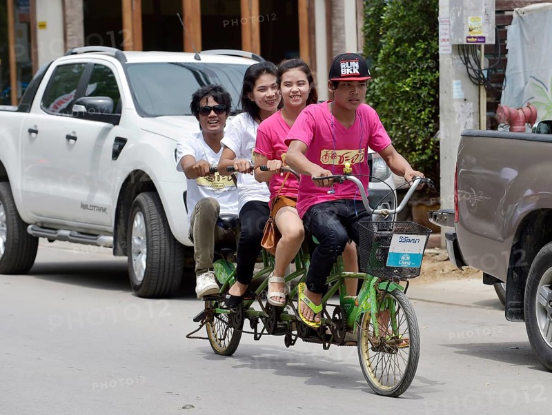 Four teenagers riding a tandem