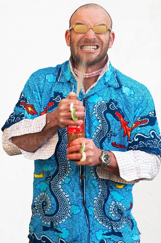 Man holding squirting soda bottle