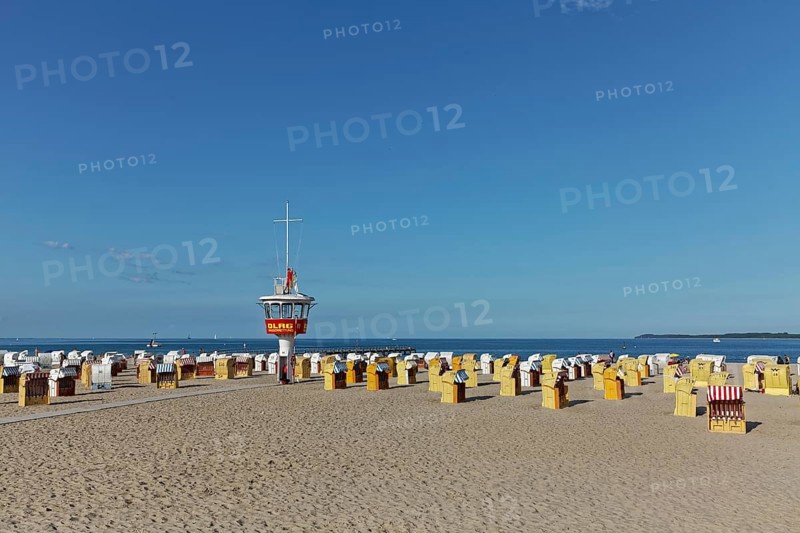 Empty sandy beach with beach chairs and DLRG-lifeguard tower