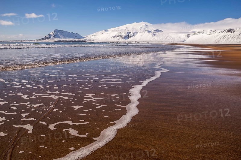 Sunny winter day on the sandy beach in front of Snaefellsjokull volcano